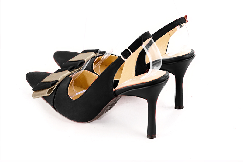Matt black and gold women's open back shoes, with a knot. Tapered toe. Very high spool heels. Rear view - Florence KOOIJMAN